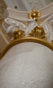 White scagliola column finishing details and gilded capital 