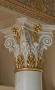 Close-up of gilded capital of white scagliola column 